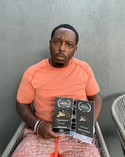 Taheim Bryan holding his Equal Standard award